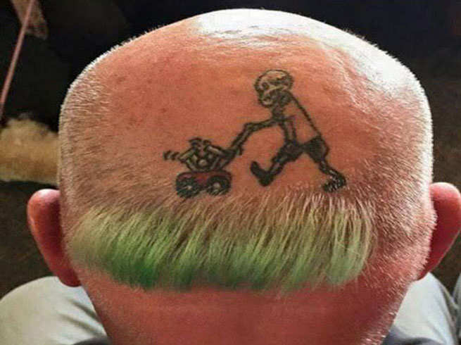 Boy With Grass Cutting Machine Head Tattoo