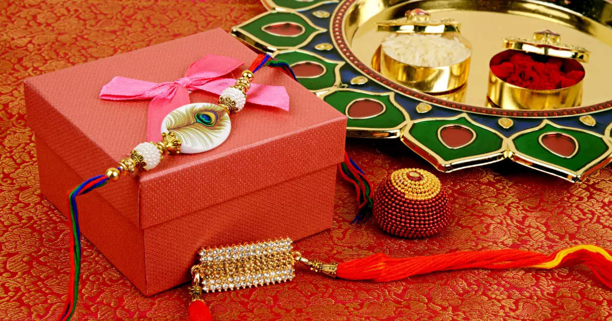 Raksha Bandhan Greeting - Rakhi And Gift With Sweet Kaju Katli Or Mithai  And Rice Grains & Kumkum In A Decorative Plate. Traditional Indian Wrist  Band Is A Symbol Of Love Between