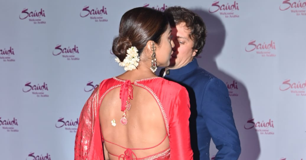 Shriya Saran Stuns in Red Banarasi Saree at Mumbai Event with Husband Andrei Koscheev