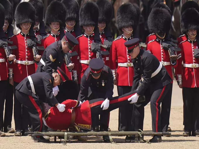 Troops feel the heat, and several faint, as Prince William reviews military parade.