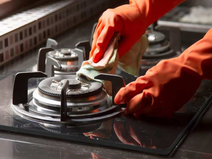Cleaning gas stove at kitchen stock photo