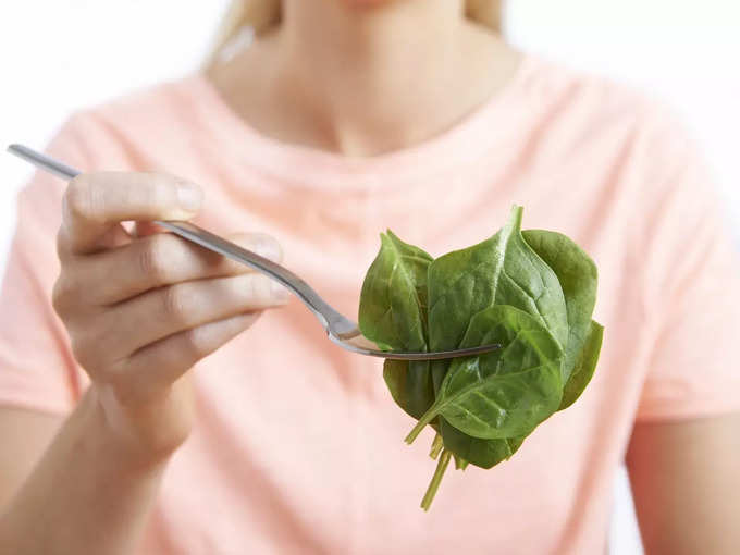 woman eating spinach
