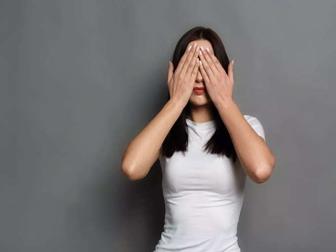 Scared woman covering eyes with hands, see no evil stock photo
