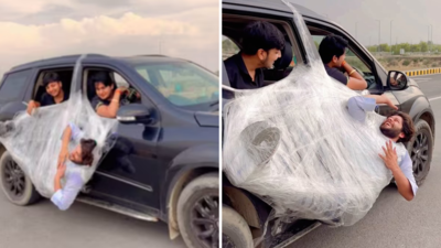 Life threatening stunt: दोस्त को प्लास्टिक में लपेट चलती गाड़ी के दरवाजे से लटकाया, वीडियो देख पब्लिक ने इन्फ्युलेंसर को बुरी तरह लताड़ा