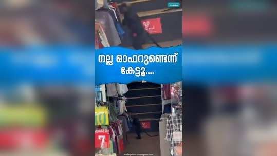 black monkey searching for clothes inside a shop in wayanad