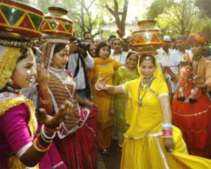 A folk dancer from Indian Rajasthan state performs during celebrations outside the residence of Congress party President Sonia Gandhi, in New Delhi