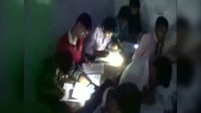 Shocking! Students forced to sit on floor, use mobile light to take exams 