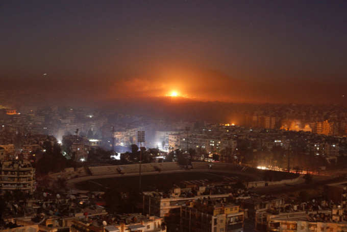 Smoke and flames coming out of the city after air strikes