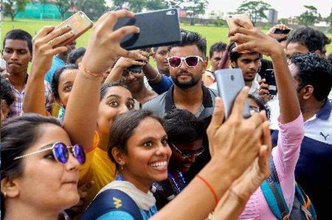 Chennai: Cricketer Suresh Raina along with his fans taking selfie during a pract...