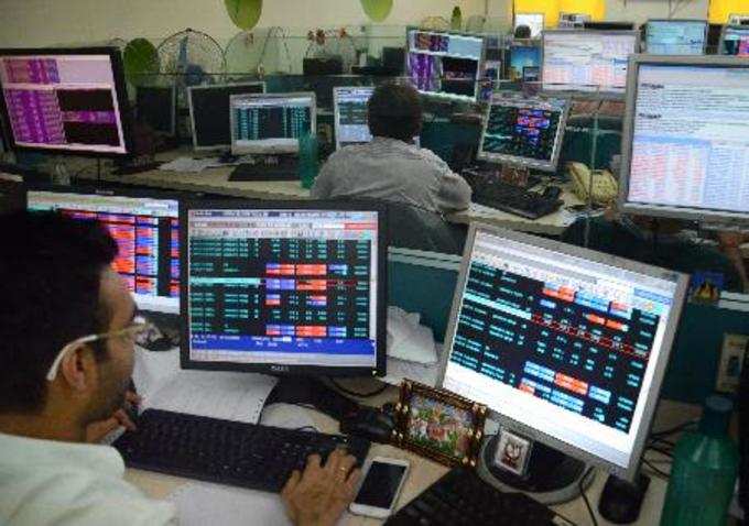 Kolkata: Sharebrokers and holders check the Sensex and Nifty at a Share market