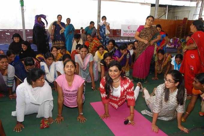 Mothers and school girls practicing yoga