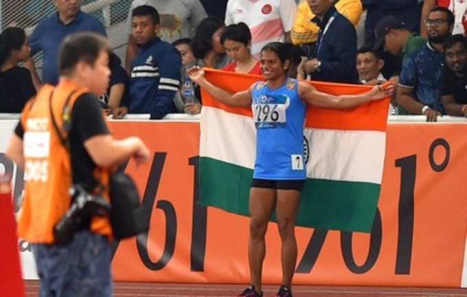 Jakarta: Silver medal winner Indian athlete Dutee Chand celebrates with national...