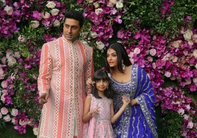 Actor Abhishek Bachchan, his wife actress Aishwarya Rai and their daughter Aaradhya pose at the wedding ceremony of Akash Ambani, son of the Chairman of Reliance Industries Mukesh Ambani, at Bandra-Kurla Complex in Mumbai
