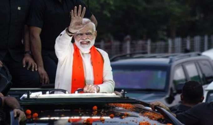 Bhubaneswar: Prime Minister Narendra Modi waves at the supporters during his ele...