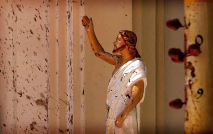 Negombo : Blood stains are seen on the wall and on a Jesus Christ statue at the ...
