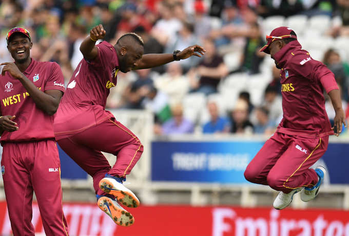 Jason Holder has a laugh as Andre Russell and Darren Bravo