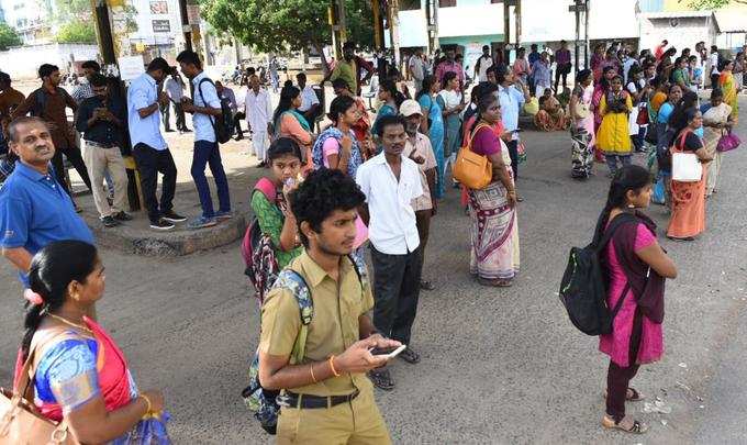 பேருந்து நிலையத்தில் காத்திருக்கும் பொதுமக்கள்