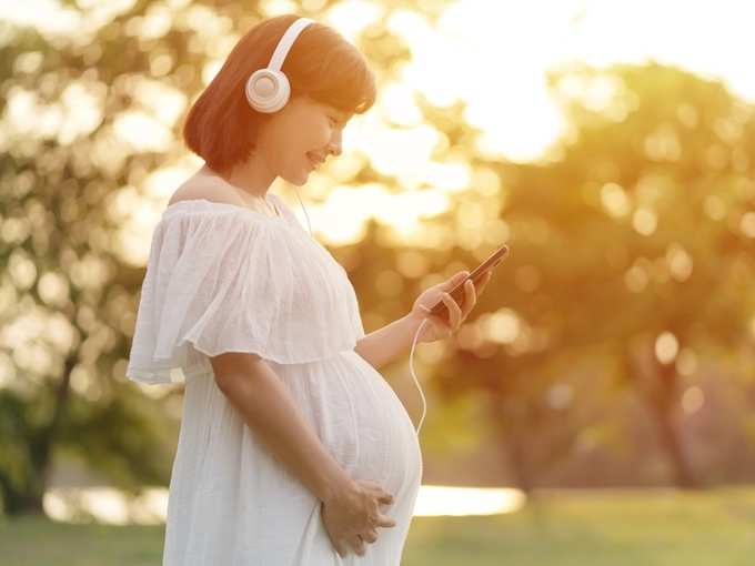 Pregnant woman listens to music