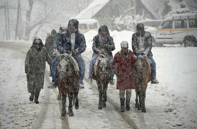 Tourists enjoy fresh snowfall in Kashmir