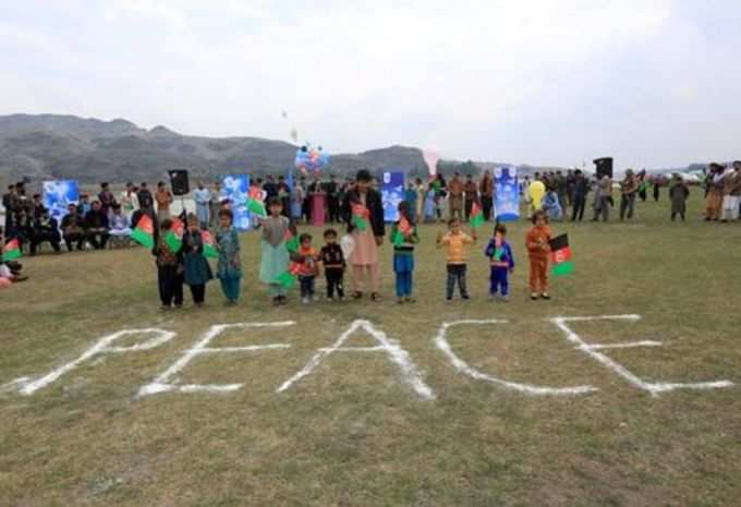 Afghan children celebrate in anticipation of the U.S-Taliban agreement to allow a U.S. troop reduction and a permanent ceasefire, in Jalalabad