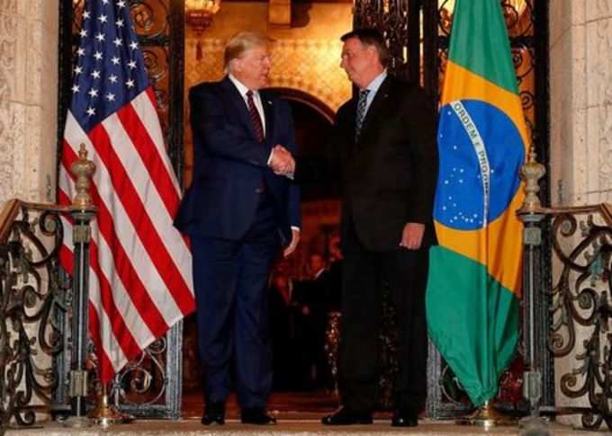 U.S. President Trump shakes hands with Brazil&#39;s President Bolsonaro at Mar-a-Lago residency in Palm Beach