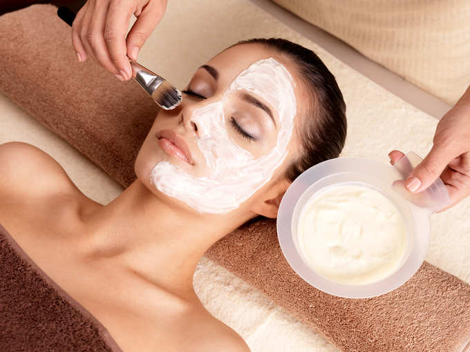 woman receiving facial mask