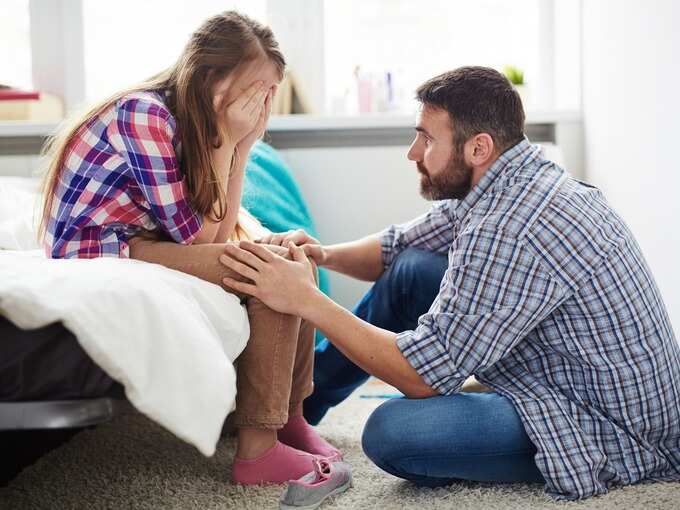 Father consoles daughter