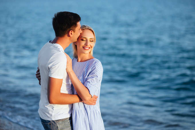 Young happy couple on beach at summer vacation