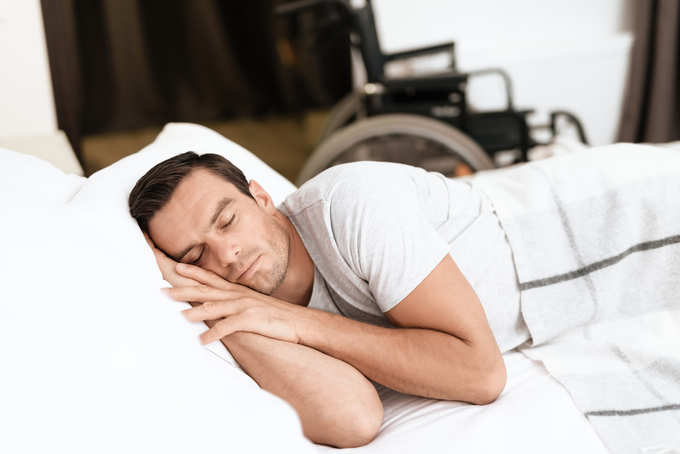 person sleeps in his white bed