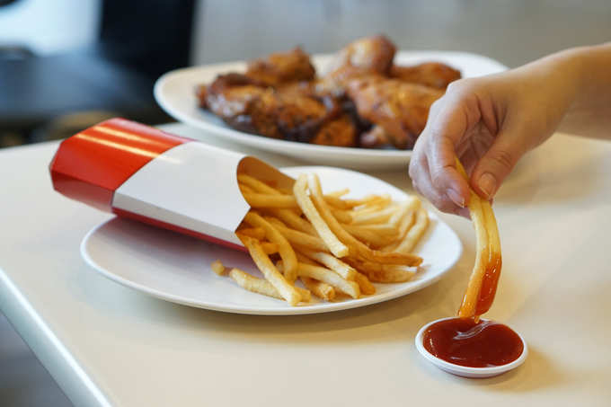 french fries dipping in ketchup