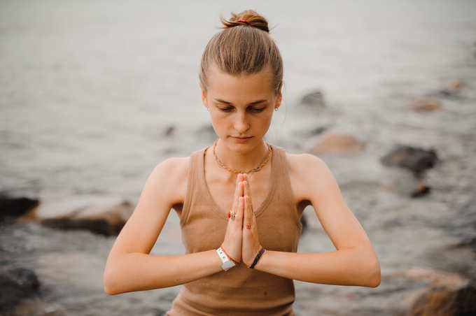 woman performing namaste gesture