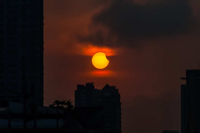 solar eclipse over building