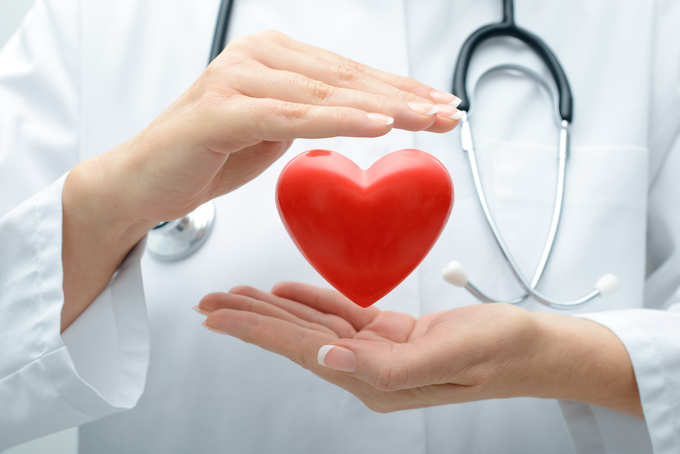 Doctor holding heart stock