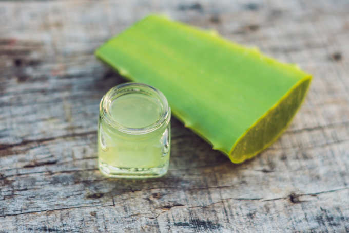 aloe vera leaf and a bottle with transparent gel