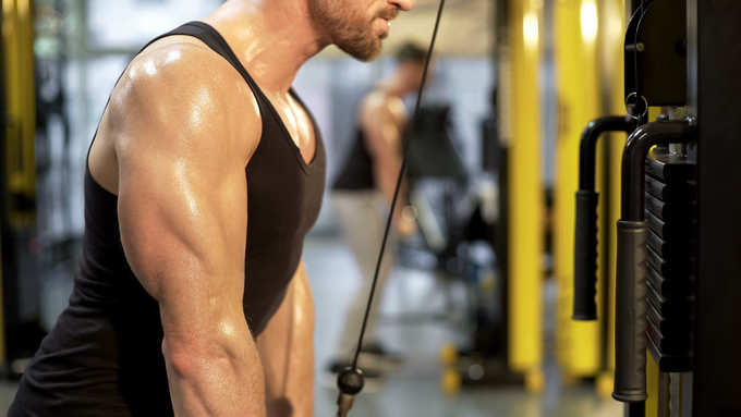 Sportsman doing pull-downs in gym