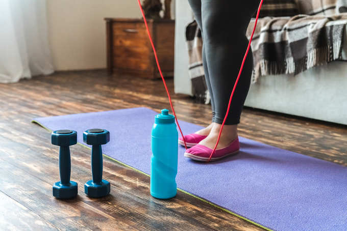 woman sport at home standing holding jump