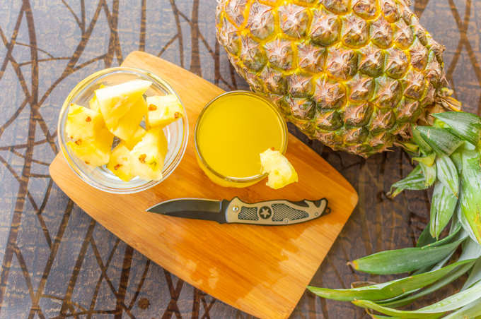 pineapple kept on a wooden table