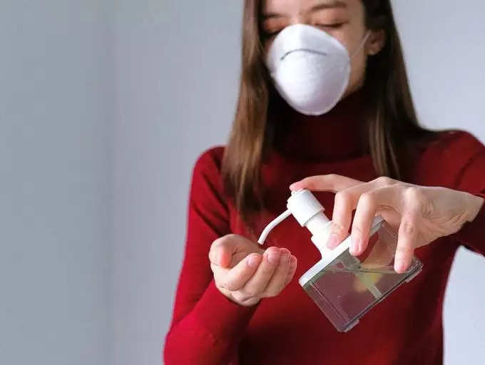 women using sanitizer
