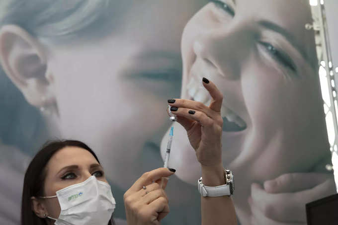 Tel Aviv: An Israeli nurse prepares a COVID-19 vaccine at a temporary vaccinatio...