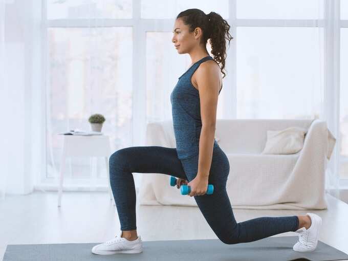 slim-hispanic-girl-doing-lunges-with-dumbbells-at-home-empty-space-picture-id1210548146 (1)