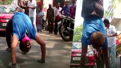 వీడియో: తలకిందులుగా నడుస్తూ కారును లాగేసిన యోగా టీచర్