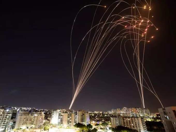 Streaks of light are seen as Israel&#39;s Iron Dome anti-missile system intercepts rockets launched from the Gaza Strip towards Israel, as seen from Ashkelon, Israel.