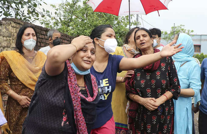 Jammu: Familyes members of BJP leader Rakesh Pandita mourn, who died in a terror...