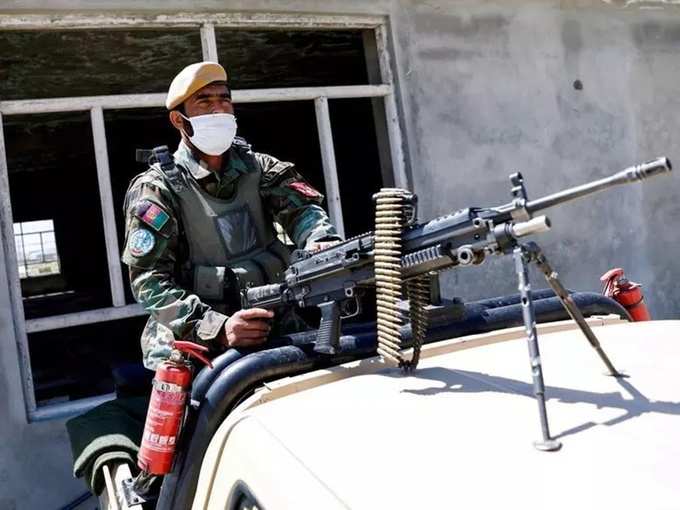 FILE PHOTO_ An Afghan National Army soldier sits on the back of an army vehicle at a checkpoint on the outskirts of Kabul on April 21, 2021.