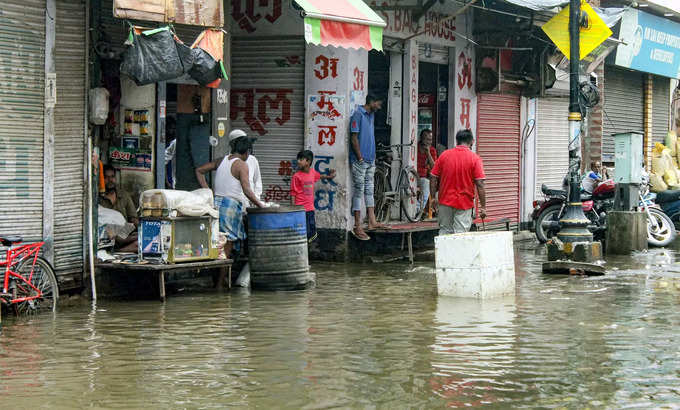 Varanasi: A flooded market after heavy rains in Varanasi. (PTI Photo) (...