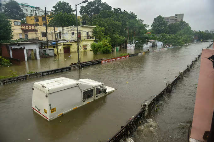Lucknow: A partially submerged vehicle due to waterlogging following heavy rains...