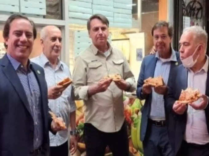 president Jair Bolsonaro was spotted eating pizza on a sidewalk