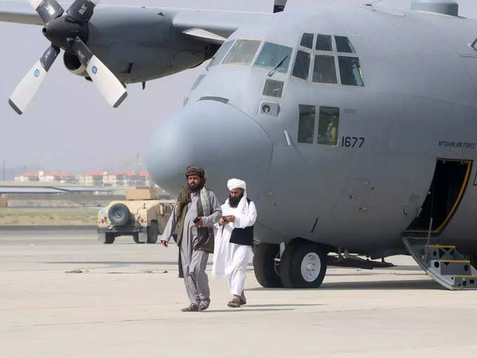 Taliban walk in front of a military airplane a day after the U.S. troops withdrawal from Hamid Karzai international airport n Kabul.