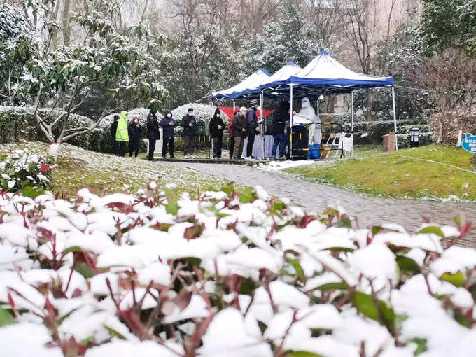 Residents line up for nucleic acid testing at a residential compound under lockdown in Xian.