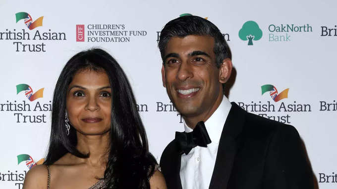 Britain&#39;s Chancellor of the Exchequer Rishi Sunak poses with his wife Akshata Murthy